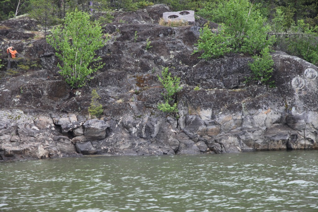 Fig. 6. The Footprints on the Kitchi Sipi (Nelson River). Near the top is the concrete slab that held two of the Footprints and in the upper right the same two Footprints now relocated back into the rock. Photograph by author, with thanks to Clifford Kobliski.